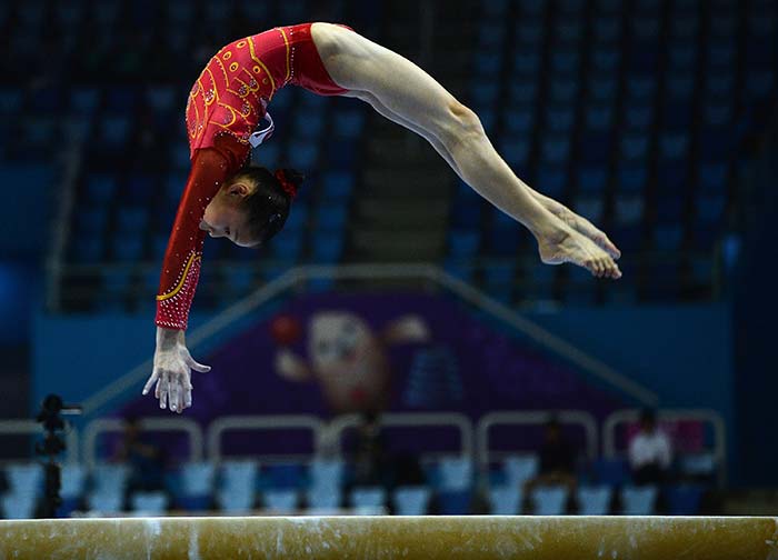 China's Shang Chunsong performs on the balance beam at the Namdong Gymnasium during the artistic gymnastics women's qualification and team final.