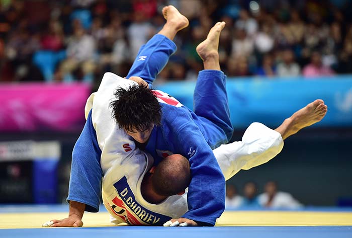 Japan's Yuya Yoshida (top) competes with Uzbekistan's Dilshod Choriev (bottom) in the men's -90kg judo final match.