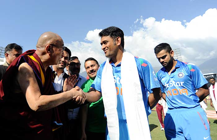 Indian captain MS Dhoni greets His Holiness Dalai Lama before the start of the 4th ODI against West Indies in Dharamsala.