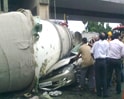 Video: Car crushed as cement mixture truck falls from flyover