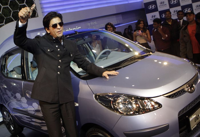 Shahrukh Khan gestures as he poses at a preview of the Hyundai i10 Electric car at the 10th Auto Expo in New Delhi.