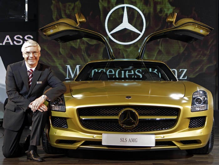 Mercedes-Benz India Chief Executive Officer Wilfried Aulbur poses with a AMG Desert Gold concept car at the 10th Auto Expo. (AP image)