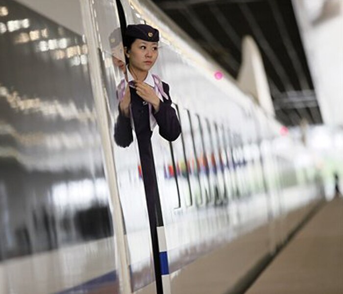 An attendant of the first bullet train of a new high-speed railway linking Shanghai with Hangzhou prepares to welcome the guests before traveling to Hangzhou on October 26, 2010 in Shanghai, China. (Photo: AFP)