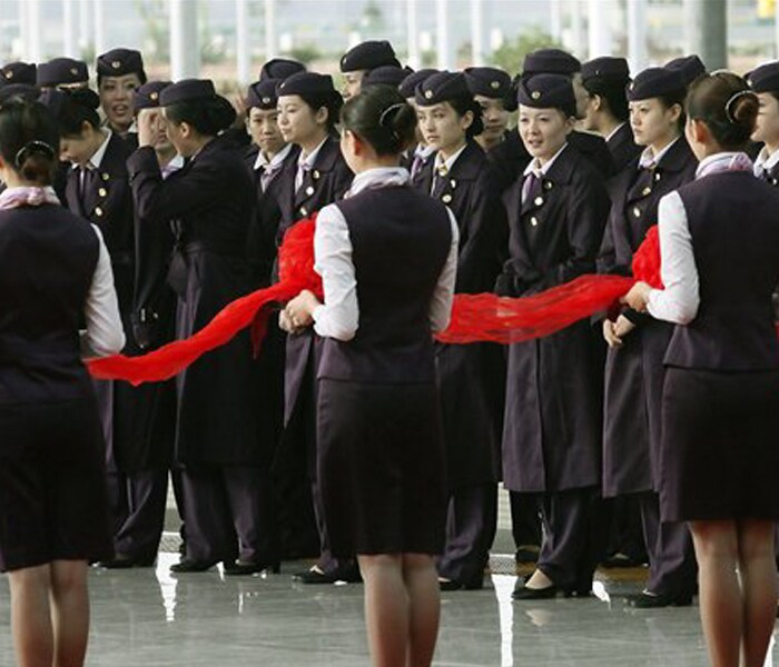 Train attendants participate in the opening ceremony of a new high-speed railway linking Shanghai with Hangzhou in Shanghai. China already has the world's longest high-speed rail network and aims to more than double its length to 10,000 miles (16,000 kilometers) by 2020. (Photo: AP)