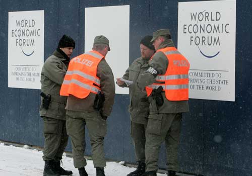 <b>Security beefed up:</b> Swiss military police stand in front of the Congress center where the participants would hope to get a clue on tackling the global meltdown not seen in the last 78 years. The likes of CII President and ICICI Bank CEO and Managing Director K V Kamath, Reliance Industries Chairman Mukesh Ambani, Kumar Mangalam Birla of the Aditya Birla Group, Anil Ambani of Reliance ADAG and Nandan Nilekani of Infosys would face questions on the unsavoury Satyam episode.