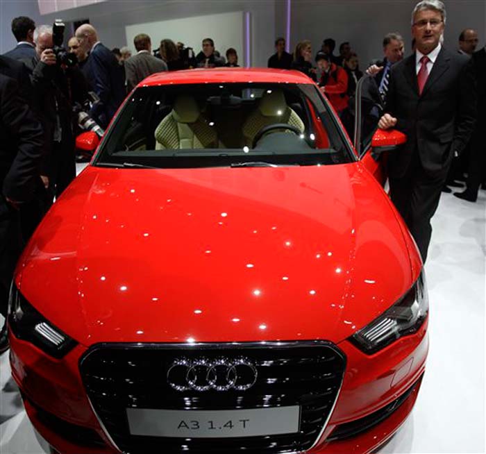 Audi CEO Rupert Stadler, right, stands with the new Audi A3 during a preview at the Geneva International Motor Show in Switzerland. For those of you who have always wondered, the four intersecting rings stand for the four companies in VW's Audi Union division ? Audi, DKW, Horch and Wanderer.