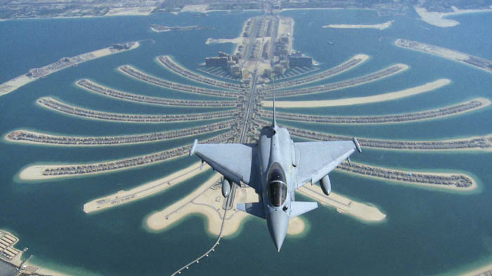 A Royal Air Force Typhoon flies over the Jumeirah Palm, Dubai?s signature palm-shaped islands built by Nakheel. The Palm Jumeirah is built in the shape of date palm tree and consist of a trunk. The bonds Nakheel, dropped sharply and the cost of insuring against a Dubai government default soared. The decision for a stay on debt repayments comes just weeks before Nakheel, the developer of Dubai?s signature palm-shaped islands was scheduled to make payment on its $3.52 billion of Islamic bonds. (AP photo)