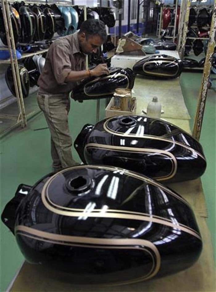 A worker paints a fuel tank at the factory. Purists still come to the company looking to buy a bike with the old engine, but they have to go to the second-hand market as production ceased in 2010.