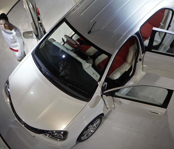 A model poses next to Toyota Etios. (AP Photo)