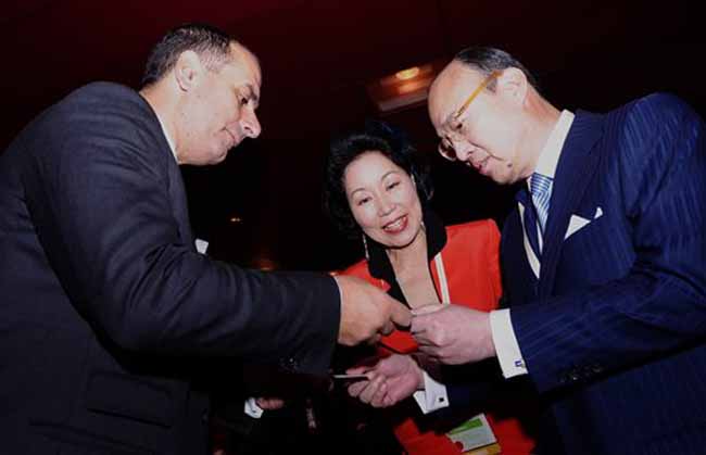 CEO of Korea's Hanwha group Kim Seung-youn exchanges name cards with CEO of the Blackstone Group financial services company Stephen A Schwarzman during a reception at the sidelines of the Summit. (AP)