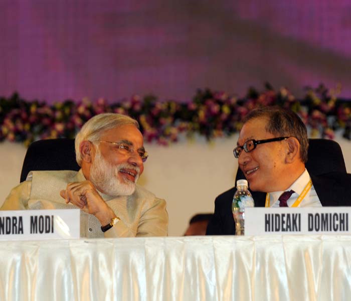 Narendra Modi and Japanese Ambassador to India Hideaki Domichi interact during Vibrant Gujarat 2011 Fifth Global Summit at Mahatma Mandir in Gandhinagar some 30 km from Ahmedabad on January 12, 2010. (Photo: AFP)