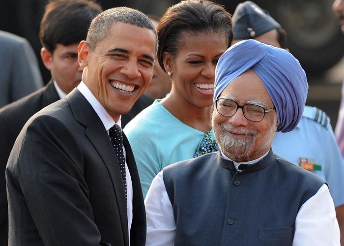 US President Barack Obama and his wife Michelle being welcomed by Prime Minister Manmohan Singh and his wife Gursharan Kaur on their arrival at Palam Air Force Station in New Delhi on Sunday. (PTI Photo)