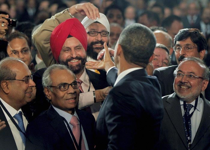 US President Barack Obama (back to the camera) greets businessmen and industrialists after speaking at the US-India Business Council and Entrepreneurship Summit in Mumbai. (PTI Photo)