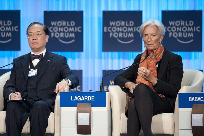 International Monetary Fund (IMF) managing director Christine Lagarde, right, gestures next to Donald Tsang, left, chief executive of Hong Kong Special Administrative Region during a plenary session of the World Economic Forum in Davos.