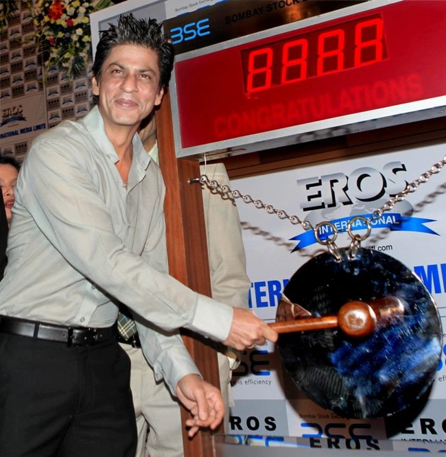 Bollywood actor Shah Rukh Khan ringing the bell at Bombay Stock Exchange during listing of Eros International Media Ltd, in Mumbai on Wednesday.<br />Eros made a strong debut on Wednesday ending 15% higher. Its IPO garnered a robust response from investors and was oversubscribed 25.76 times.