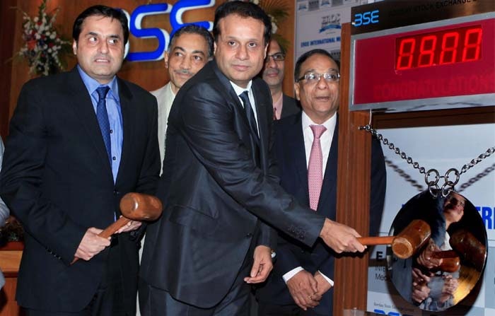 Eros International Media Ltd Group executive chairman Kishore Lulla, along with 
executive vice-chairman Sunil Lulla (L), rings the bell at Bombay Stock Exchange during listing of the company, in Mumbai on Wednesday.<br />The shares of the firm opened at Rs 213 on the day of its listing, up 21 per cent, on the BSE and at Rs 205.45, up 17 per cent on the NSE. (PTI)