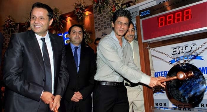 This fiscal, Eros is all set to release about seven to eight big budget movies (above Rs 40 crore) such as 'Ra.One' starring Shah Rukh Khan and 'Agent Vinod' with Saif Ali Khan.br />Bollywood actor Shah Rukh Khan along with Eros International Media Ltd Group executive chairman Kishore Lulla (L) and executive vice-chairman Sunil Lulla (C)ringing the bell at Bombay Stock Exchange during listing of the company, in Mumbai on Wednesday. (PTI)
