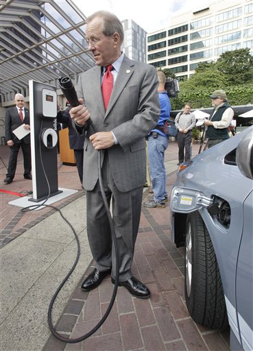 Oregon Gov. Ted Kulongoski prepares to charge a Toyota Prius Hybrid during the unveiling of the Blink electric vehicle charging station. (AP Photo)