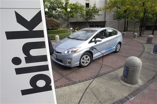 A Toyota Prius Hybrid charges during the unveiling of the Blink electric vehicle charging station. (AP Photo)