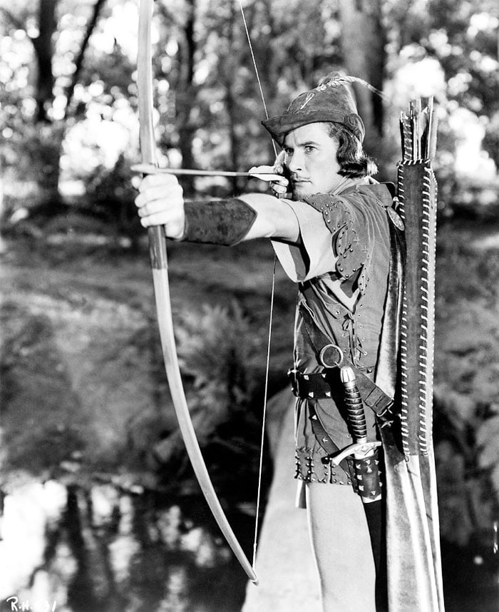 <b>The Adventures of Robin Hood</b> (1938): <b>Directed by</b> Michael Curtiz. <b>Starring</b>: Errol Flynn, Olivia de Havilland, Basil Rathbone, Claude Rains. <b>Memorable Quote</b>: "Ho, varlets, bring Sir Robin food! Such insolence must support a healthy appetite!" (Prince John)