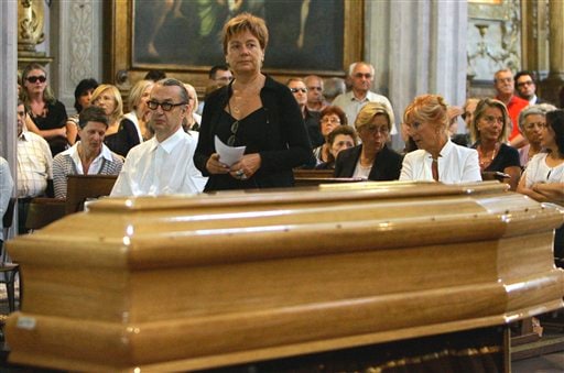 German film director Wim Wenders, left, sits next to Enrica Fico, the widow of late Italian director Michelangelo Antonioni near the coffin of her husband during the funeral at the St Giorgio cathedral in Ferrara, Italy, Thursday, Aug 2, 2007.