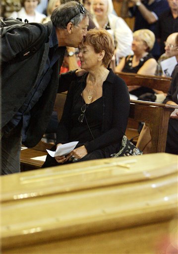 Enrica Fico, right, the widow of late Italian director Michelangelo Antonioni is hugged by an unidentified friend near the coffin of her husband at the St Giorgio cathedral in Ferrara.