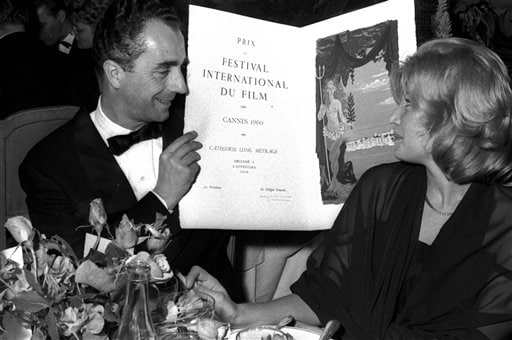 Antonioni shows his Special Jury prize for l'Aventura  to Italian actress Monica Vitti, at the Cannes film festival , May 20, 1960.