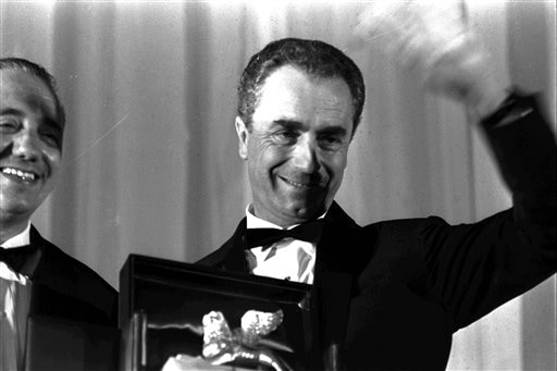 Antonioni waves at the Venice Film Festival, in Venice, Italy, in this Sept 16, 1964 file picture.