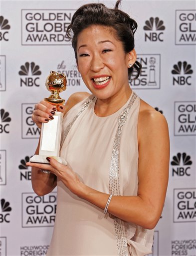 Sandra Oh poses with the award she won for best supporting actress in a series, mini-series or television movie for her work on <I>Grey's Anatomy,</I> at the 63rd Annual Golden Globe Awards.