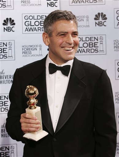 George Clooney poses with the award he won for best supporting actor for his work in <I>Syriana,</I> at the 63rd Annual Golden Globe Awards.