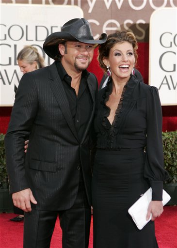 Country singer Tim McGraw, left, arrives with his wife, singer Faith Hill for the 63rd Annual Golden Globe Awards.