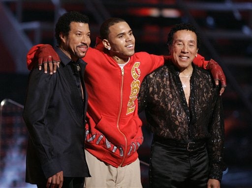 Lionel Richie, Chris Brown and Smokey Robinson, left to right, acknowledge the audience after their performances at the 49th Annual Grammy Awards
