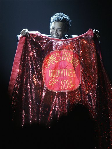Danny Ray, the man who had the responsibility for James Brown's cape through the years, holds up his cape in honor of Brown who passed in December during the 49th Annual Grammy Awards