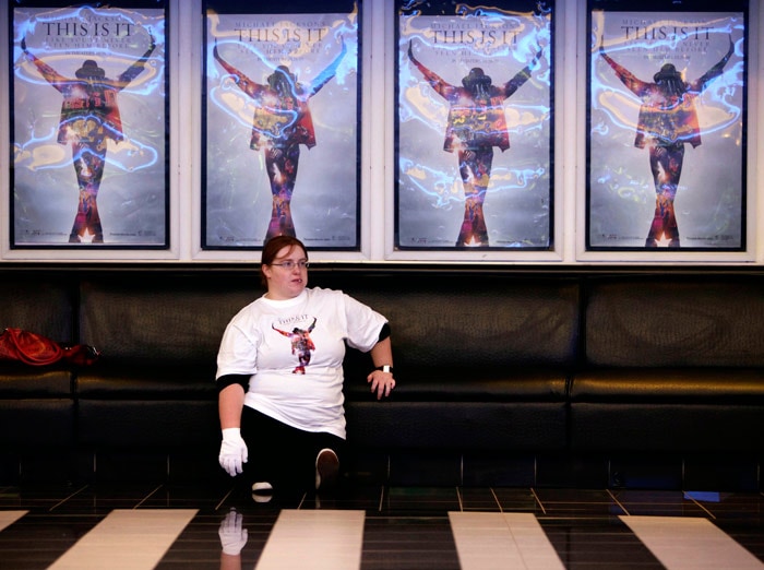 A fan waits for the start of the premiere of the Michael Jackson movie "This Is It" in Johannesburg, South Africa, Wednesday, Oct. 28, 2009. (AP Photo/Denis Farrell)