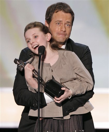 Greg Kinnear holds up Abigail Breslin as she accepts the award for outstanding performance by a cast in a motion picture for their work in Little Miss Sunshine, at the 13th Annual Screen Actors Guild Awards.