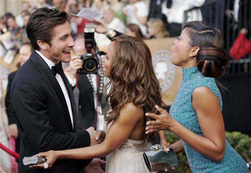 Jake Gyllenhaal, nominated for outstanding performance by a male actor in a supporting role for his work in Brokeback Mountain, left, greets actress Elise Neal, center and Taraji P. Henson as they arrive for the 12th Annual Screen Actors Guild Awards.