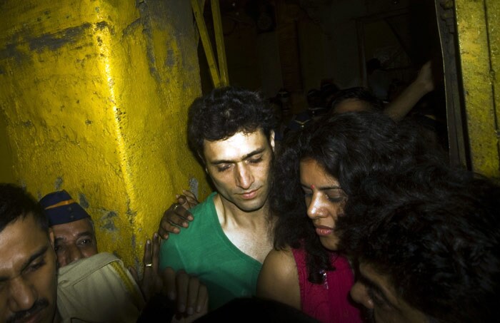 Ahuja has told the court he will move to Delhi to stay with his parents. Here he is seen leaving the Arthur Road jail in Mumbai on Saturday, Oct. 3, 2009, accompanied by his wife Anupam Ahuja. (Photo: AP)
