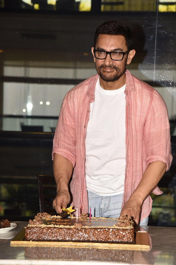 Aamir Khan posed for shutterbugs as he cut the cake.