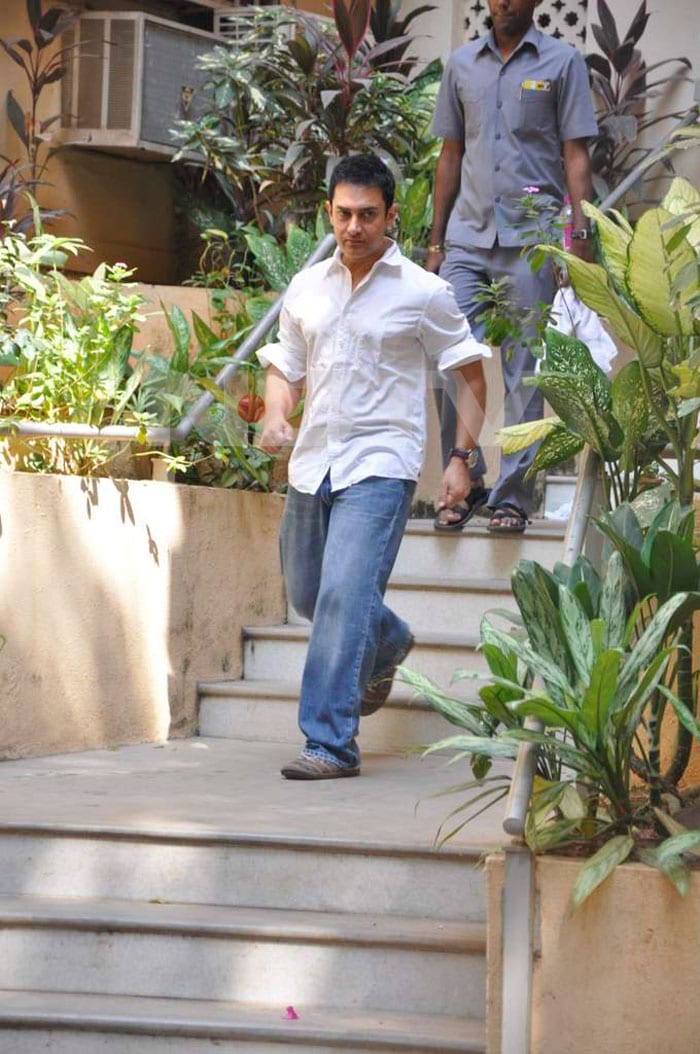 Aamir Khan walks down the stairs to attend his birthday party.