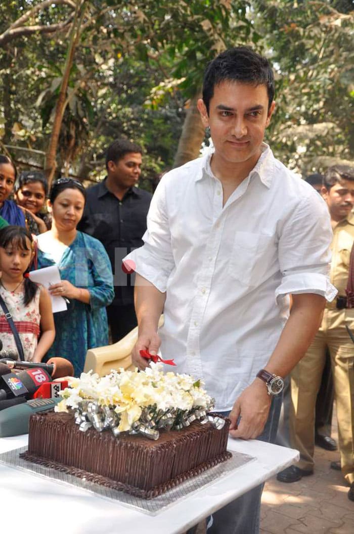 Aamir Khan gets ready to cut his birthday cake.