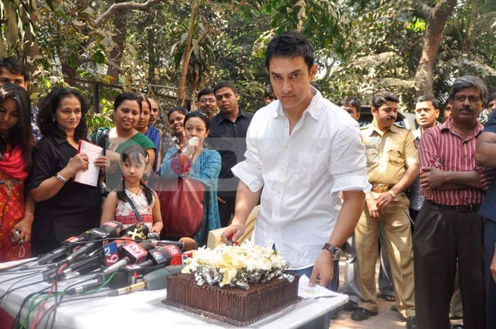 Aamir Khan gets ready to cut his birthday cake.