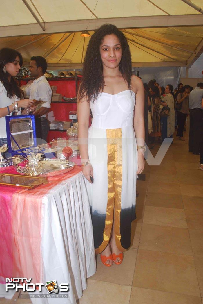 Designer Masaba Gupta in a white dress embellished with a golden border.