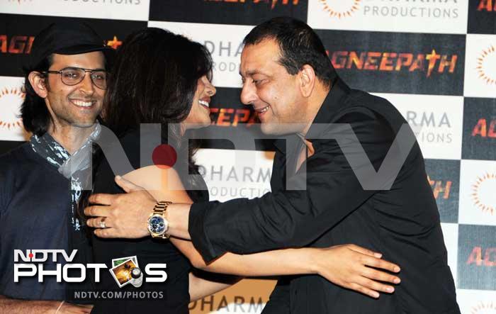 Priyanka hugs Sanjay, while Hrithik watches.