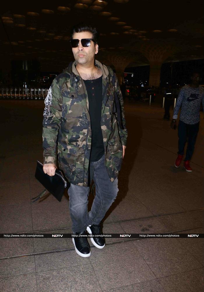 Filmmaker Karan Johar was seen in a black T-shirt, faded grey jeans and a camouflage jacket.