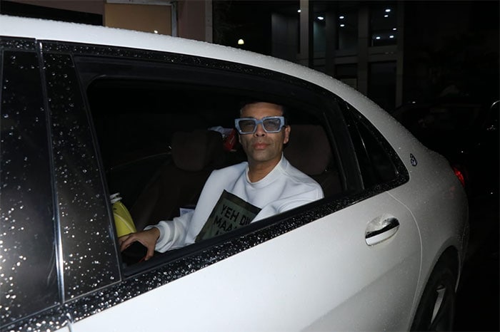 Karan Johar, who produced the film, smiled for the camera from his car.