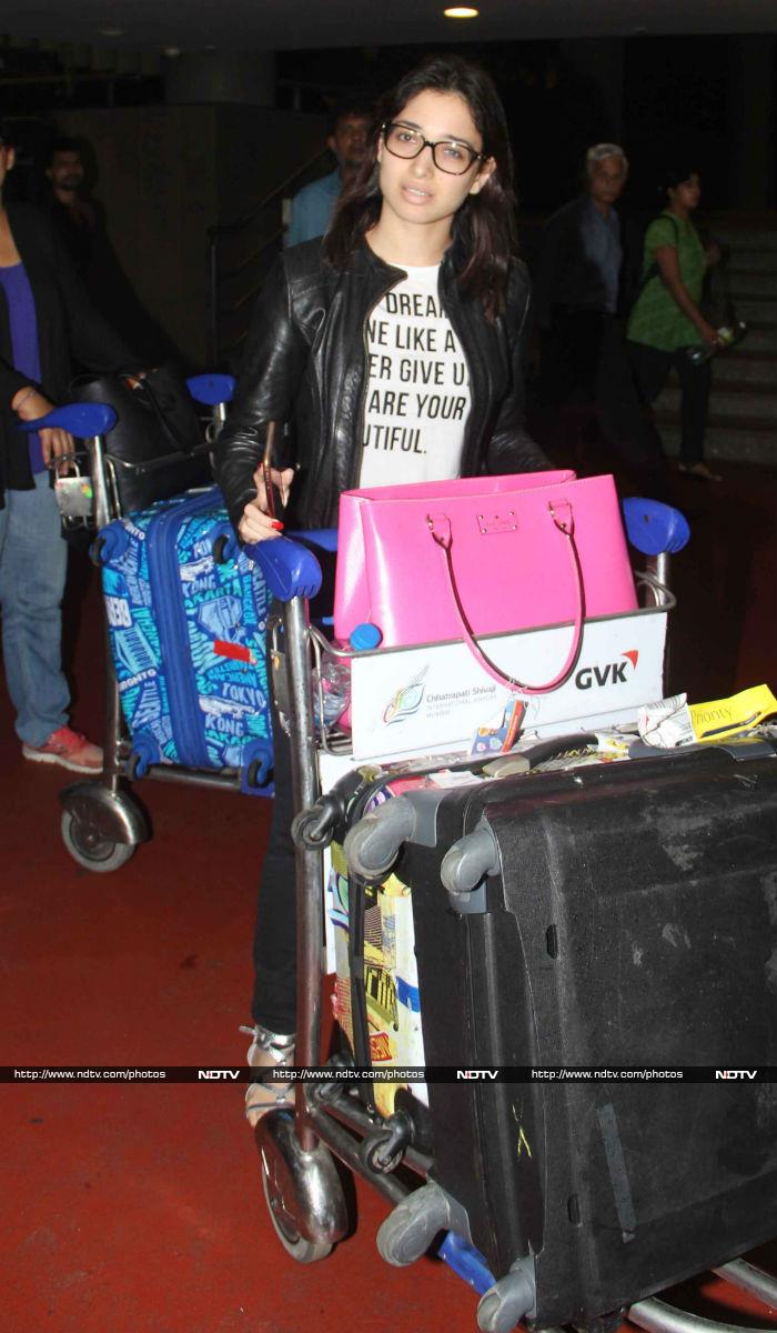 Tamannaah Bhatia navigated her way through the paparazzi with her luggage.