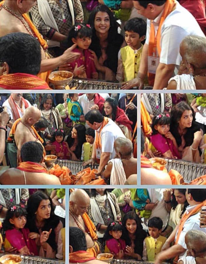 Aaradhya looked shy as Aishwarya helped her interact with the priests. <br><br>This image was posted on Facebook by <a href=" https://www.facebook.com/AishwariyaRaiBachchan/?ref=page_internal" target="_blank" rel="nofollow" >Aishwarya Rai Bachchan</a>