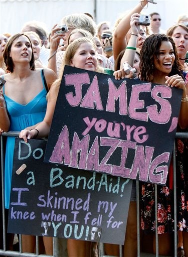 Tulane students Stephanie Leiting 19, center, and Marlisa White 18, right, hold signs for the stars as they arrive at a screening of All The King's Men at McAlister Auditorium at Tulane University in New Orleans.