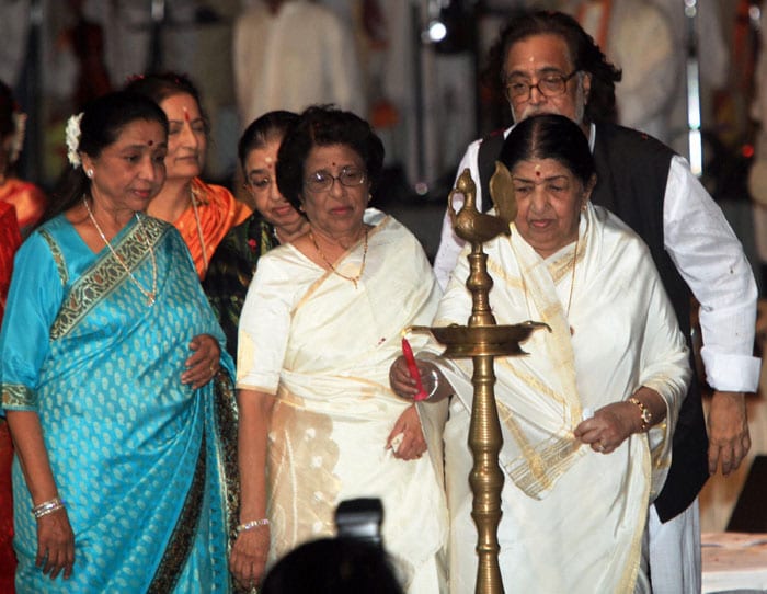 Lata Mangeshkar lights a lamp in the presence of her brother Hridaynath Mangeshkar and sisters Asha Bhosle and Usha Mangeskar during a ceremony in Kolkata to commemorate the 70th death anniversary of Rabindranath Tagore.