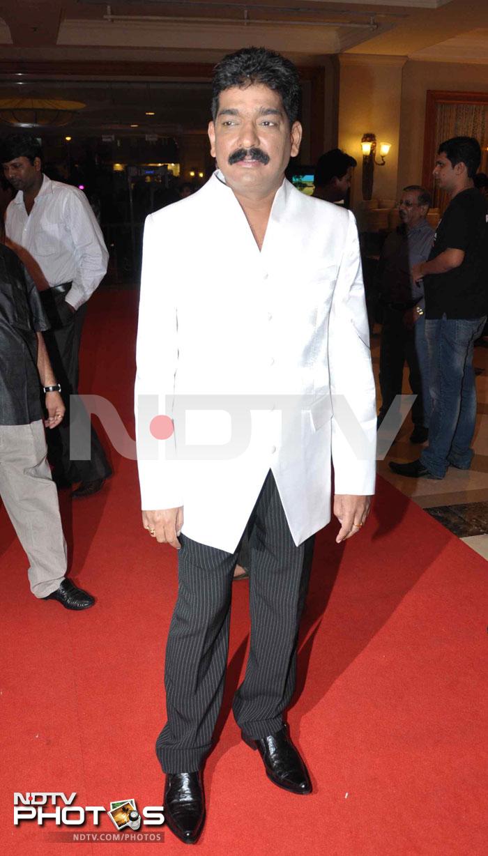 Author Nitin Desai dressed formal for the occasion with a white coat teamed with pin-striped trousers.